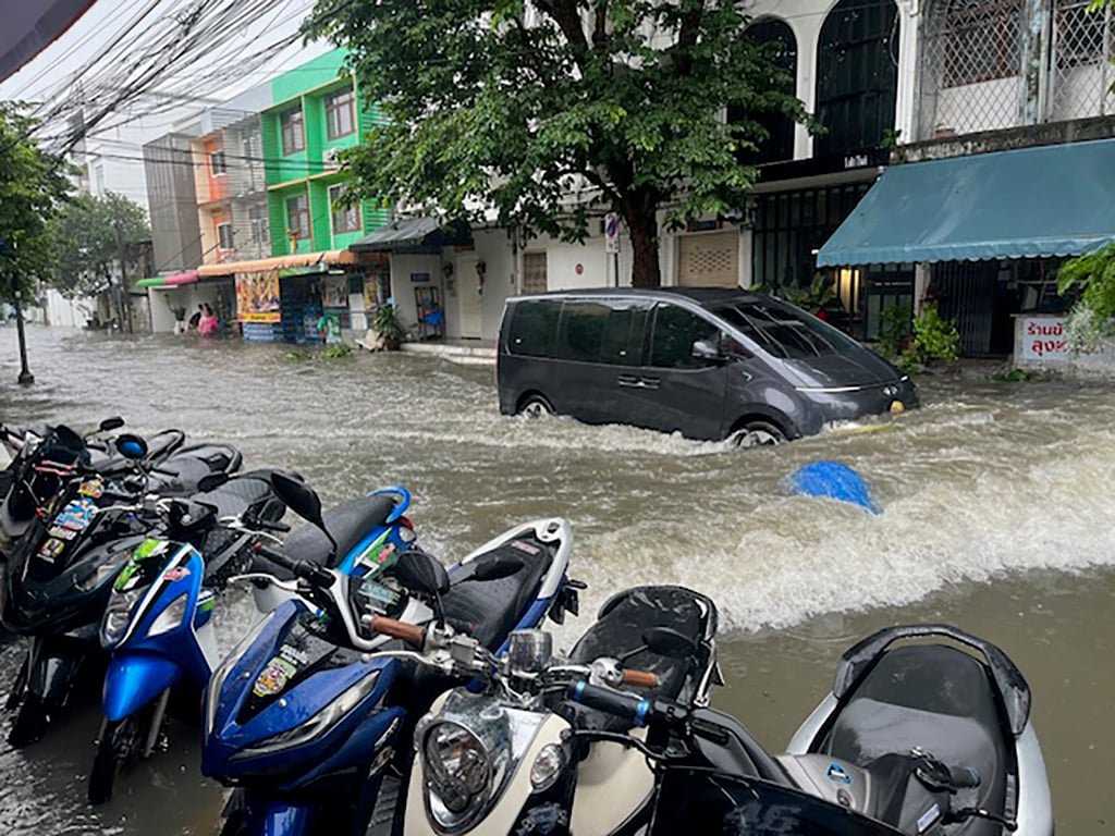 A van drives through floodwaters in the Pra Kanong district, a hodgepodge of markets, hotels, cafes and bars on the main Sukhumvit Road. Photo: Aidan Jones A van drives through floodwaters in the Pra Kanong district, a hodgepodge of markets, hotels, cafes and bars on the main Sukhumvit Road. Photo: Aidan Jones